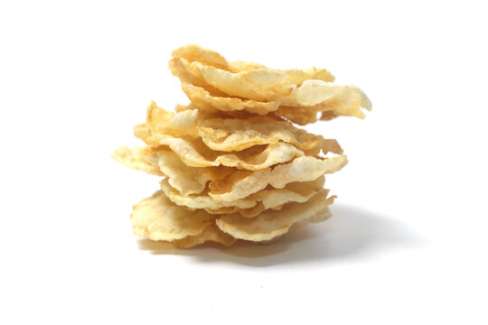 a stack of Emping, a traditional Indonesian snack made from melinjo nuts (Gnetum gnemon). These crackers have a distinct pale-yellow color with slightly browned edges from being fried