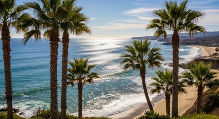 Obraz premium A picturesque beach scene with a clear blue sky, white waves crashing against the sandy shore, and palm trees swaying gently in the breeze.