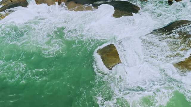 Top down view of tropical coastal line with rocks and huge waves with white foam  

aerial, drone, drone view, aerial view, waves background, waves texture, waves hitting rocks, water texture, tropica