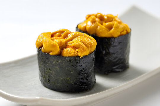Perfectly Presented Uni Gunkan Maki Sushi on a White Plate for Authentic Culinary Delight