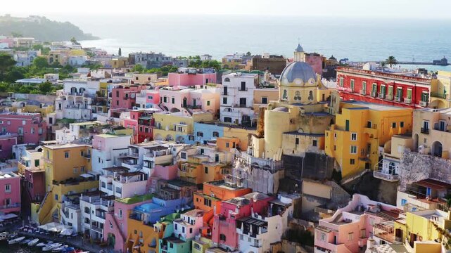 Historic harbor and pastel buildings of Procida at golden hour