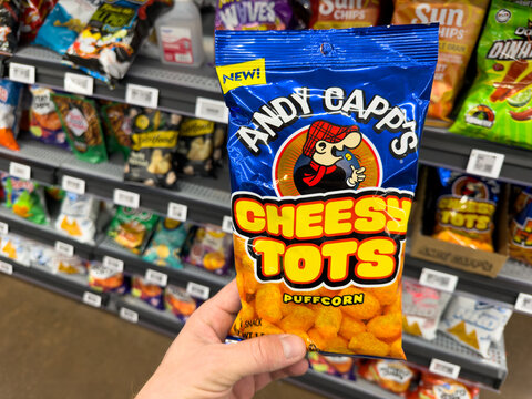 Andy Capp Cheesy Tots Puffcorn Snack Bag Held In Store Aisle