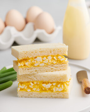 Tamago sando, Japanese egg salad sandwich, on a light background.