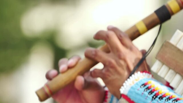Indigenous musician playing traditional flute and panpipe during cultural celebration