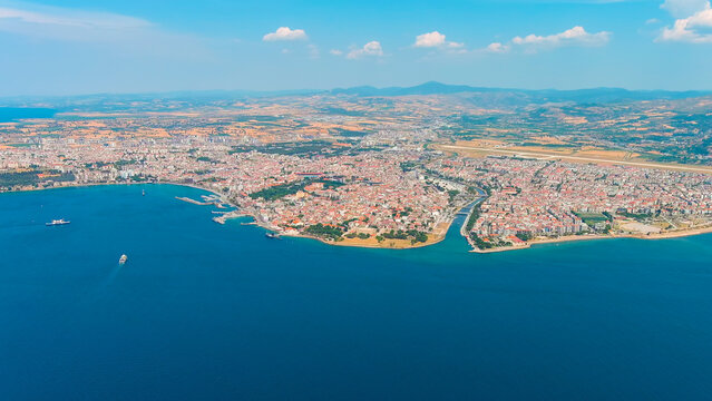 Canakkale, Turkey. Panoramic aerial view of the city on the Asian shore of the Dardanelles Strait, a vibrant Turkish port with ferry terminals and waterfront promenade on a sunny day. Aerial view