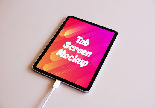Tablet Screen Mockup on Neutral Background with Charging Cable and Colorful Gradient Display