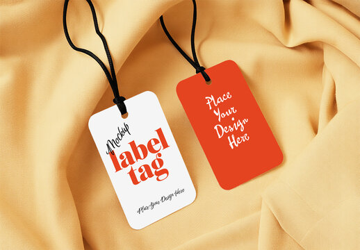 Two Clothing Label Tag Mockups with Black String on Beige Fabric Texture Background