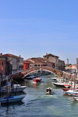Fototapeta premium Ponte San Donato (San Donato Bridge) over Canale di San Donato (San Donato Canal) viewed from Ponte San Martino (San Martino Bridge) in Murano, Italy