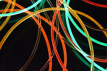 Beautiful unique, glowing backdrop made of transparent plastic tubes with red, green, yellow,...