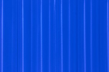 Fototapeta premium Abstract ribbed smooth deep blue striped plastic pattern or texture as background