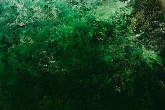 Abstract green background. Moving smoke flow, fluid liquid art.