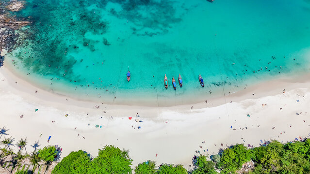 Stunning aerial view of the beach. An aerial photograph of the beautiful tropical beach and sea on Phuket Island. Located at Freedom Beach, Phuket, Thailand, at 10 am &ndash; the start of sunbathing, summer