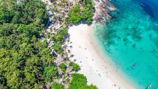 Stunning aerial view of the beach. An aerial photograph of the beautiful tropical beach and sea on Phuket Island. Located at Freedom Beach, Phuket, Thailand, at 10 am &ndash; the start of sunbathing, summer