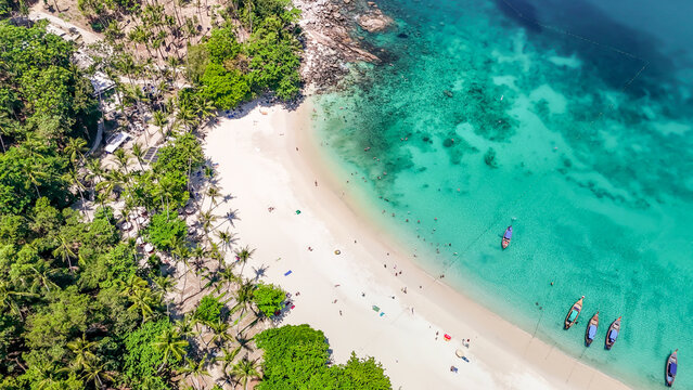 Stunning aerial view of the beach. An aerial photograph of the beautiful tropical beach and sea on Phuket Island. Located at Freedom Beach, Phuket, Thailand, at 10 am &ndash; the start of sunbathing, summer