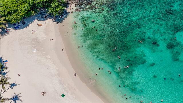 Stunning aerial view of the beach. An aerial photograph of the beautiful tropical beach and sea on Phuket Island. Located at Freedom Beach, Phuket, Thailand, at 10 am &ndash; the start of sunbathing, summer