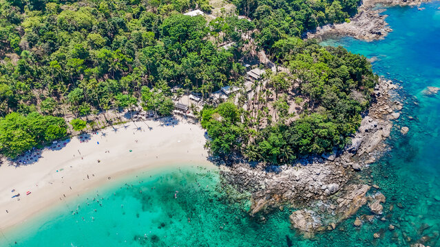 Stunning aerial view of the beach. An aerial photograph of the beautiful tropical beach and sea on Phuket Island. Located at Freedom Beach, Phuket, Thailand, at 10 am &ndash; the start of sunbathing, summer