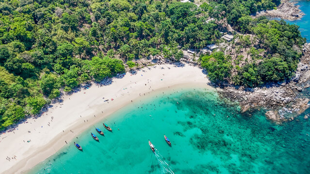 Stunning aerial view of the beach. An aerial photograph of the beautiful tropical beach and sea on Phuket Island. Located at Freedom Beach, Phuket, Thailand, at 10 am &ndash; the start of sunbathing, summer