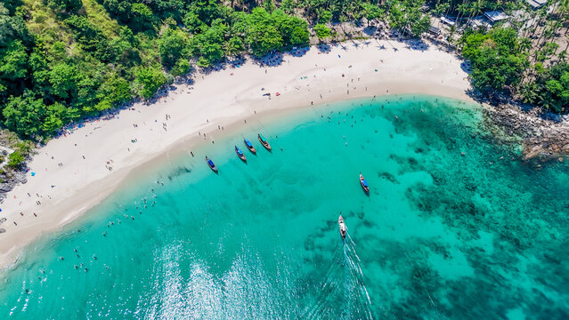 Stunning aerial view of the beach. An aerial photograph of the beautiful tropical beach and sea on Phuket Island. Located at Freedom Beach, Phuket, Thailand, at 10 am &ndash; the start of sunbathing, summer