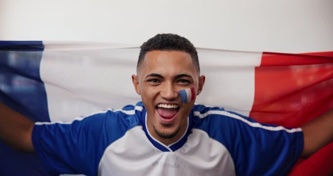 Soccer game, face and man in house with flag, goal excitement or celebration in sports tournament. POV, supporter or football fan in home with victory, score lead and winning shout in France.