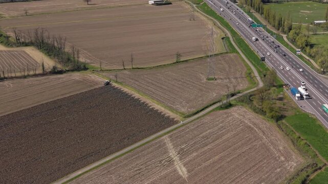Aerial view of farmlands and highway: A sprawling landscape of farmlands and a bustling highway converge, showcasing the symbiotic relationship between agriculture and transportation.