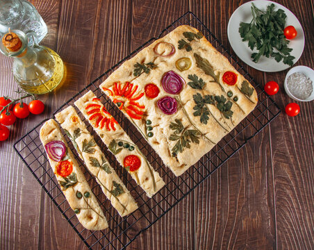 Rustic Italian focaccia with floral vegetable art topping