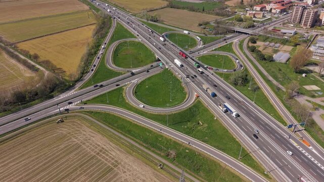 Expressway Cloverleaf Intersection: A high-angle perspective captures the dynamic flow of traffic through a complex cloverleaf intersection.
