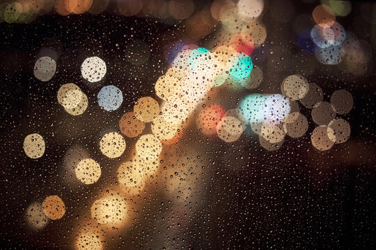 Abstract rainy window bokeh city lights with motion blur