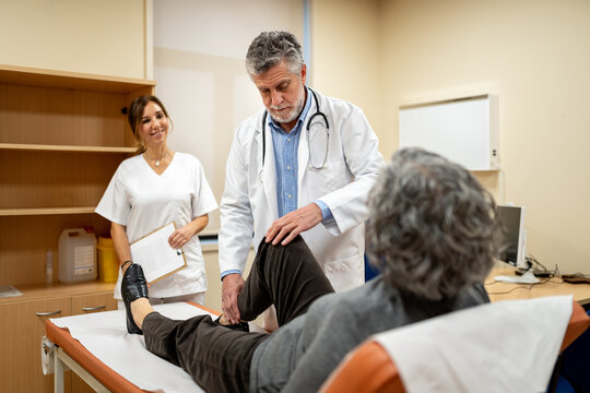 Doctor examining patient with nurse's assistance