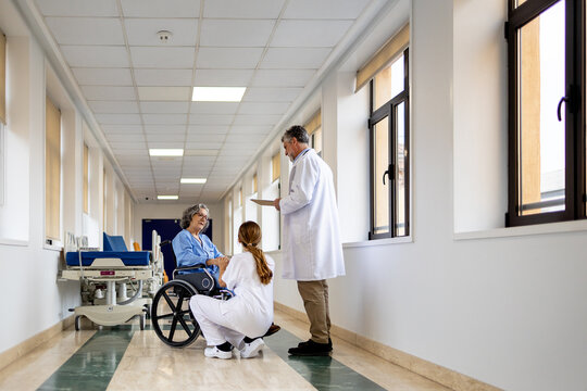 Doctors attending to a patient in a hospital hallway