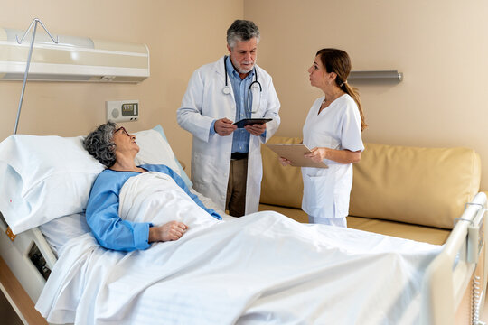 Doctors attending to a patient in hospital room