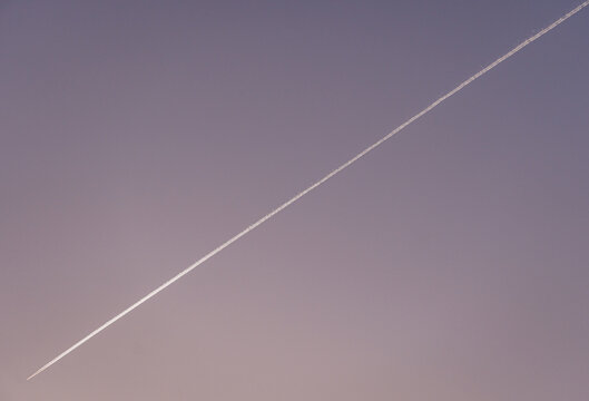 Airplane contrail against a clear sky