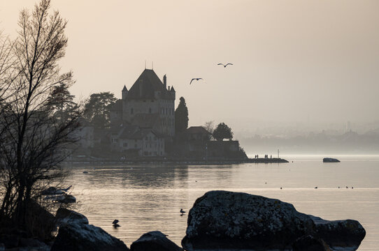 Tranquil Yvoire Castle overlooking lake at sunset