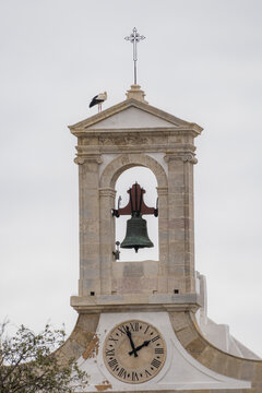 Bell tower with stork and clock in Faro, Portugal