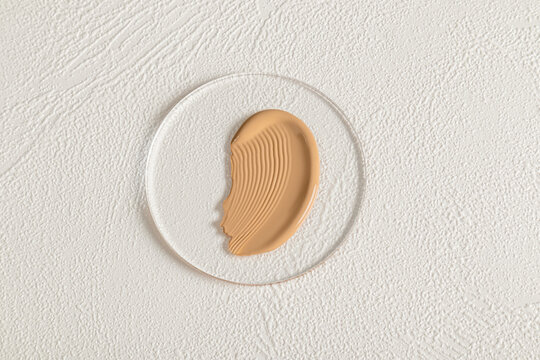 Foundation swatch on textured white background