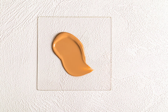Foundation sample over textured white background