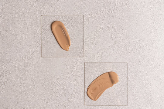 Foundation samples on textured white background