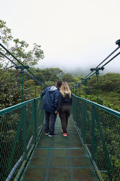 Couple exploring Monteverde rainforest canopy bridge