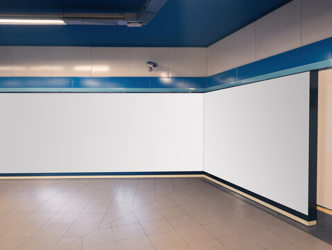 Blank billboard in modern indoor shopping mall area