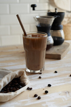 Gourmet chocolate iced mocha with wooden straw in kitchen