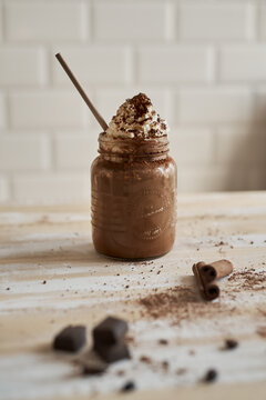 Chocolate milkshake in mason jar with whipped cream