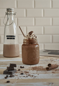Chocolate milkshake in mason jar with whipped cream