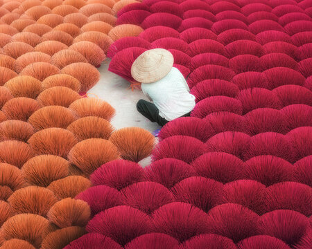 Artisan sorting vibrant incense sticks