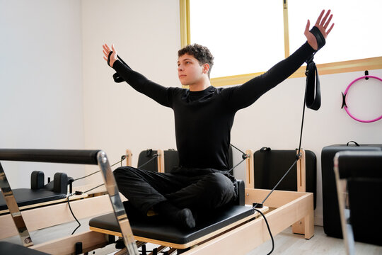 Pilates enthusiast practicing on reformer equipment