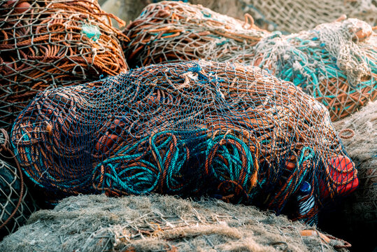 Fishnet pile in harbor with tangled ropes and gear
