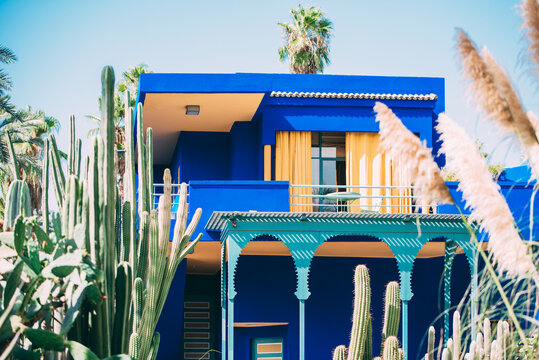 Colorful blue house amid cactus garden in Marrakech, Morocco
