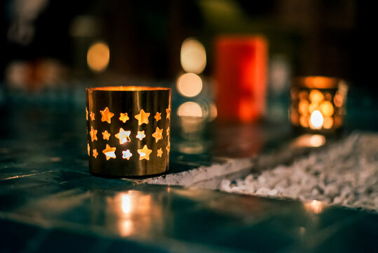 Light up candle holder with star pattern and warm bokeh