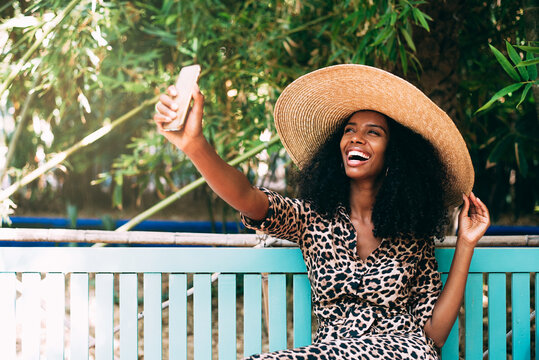 Woman taking a selfie on mobile phone in a lush garden