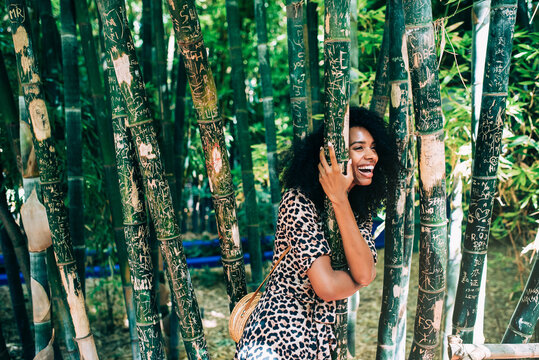 Cheerful woman enjoying a lush garden moment in Morocco