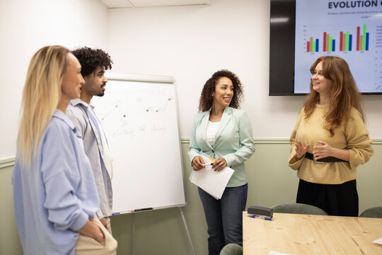 Diverse coworking team meeting with presentation in office