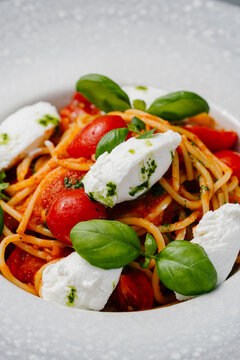 Pasta with cherry tomato and burrata, basil and garlic